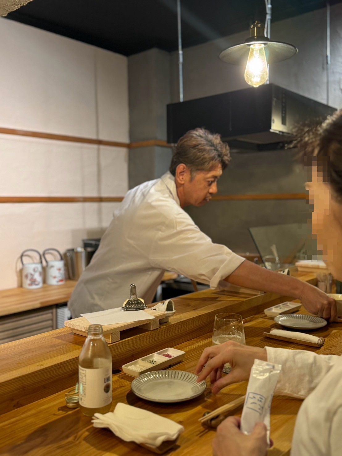 カウンターで料理をお出しする店主